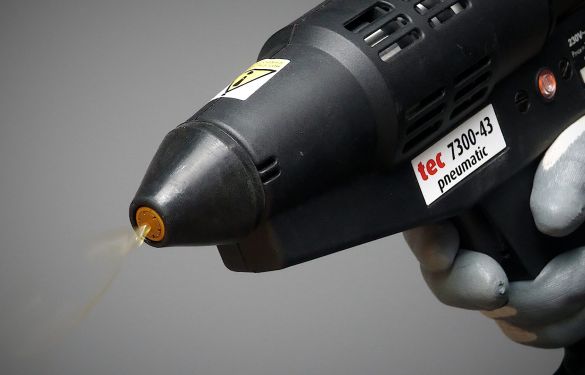 How does the spraytec system work compared to regular spray adhesives?