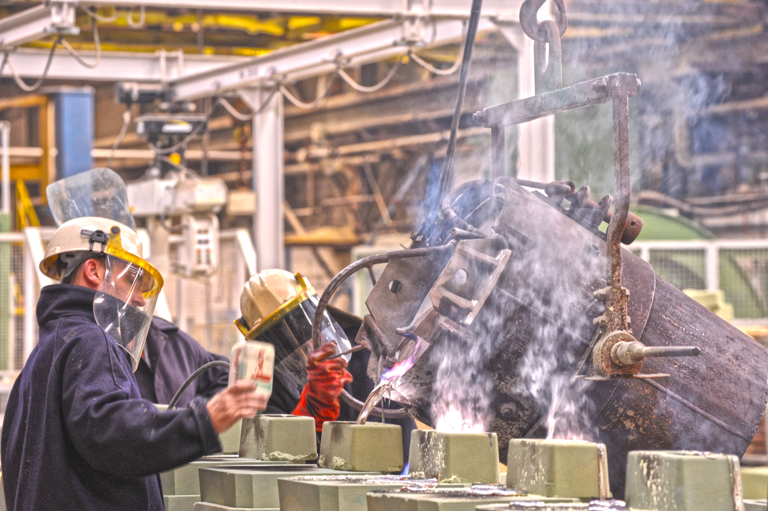 Pouring molten metal into sandcore mold